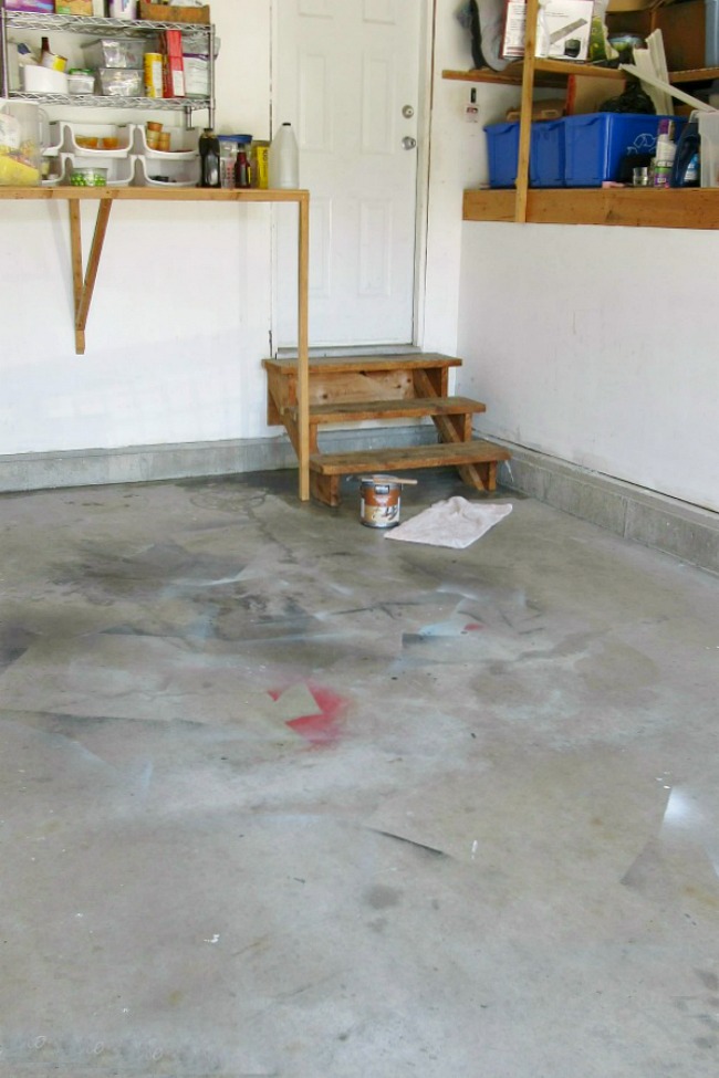 Before photo of a painted garage floor.